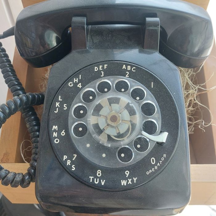 An old black rotary telephone