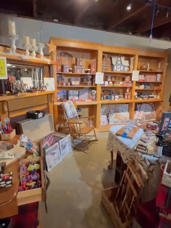 The upstairs gift floor, wooden shelves of gifts under the timber beams